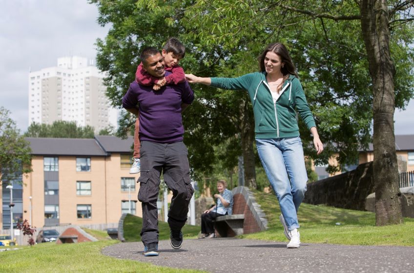 A happy family walking through the park